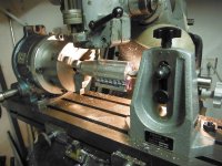 Yuasa rotary table, 3 jaw chuck, and tailstock mounted on mill table to  make a cut on 1885 scop.jpg